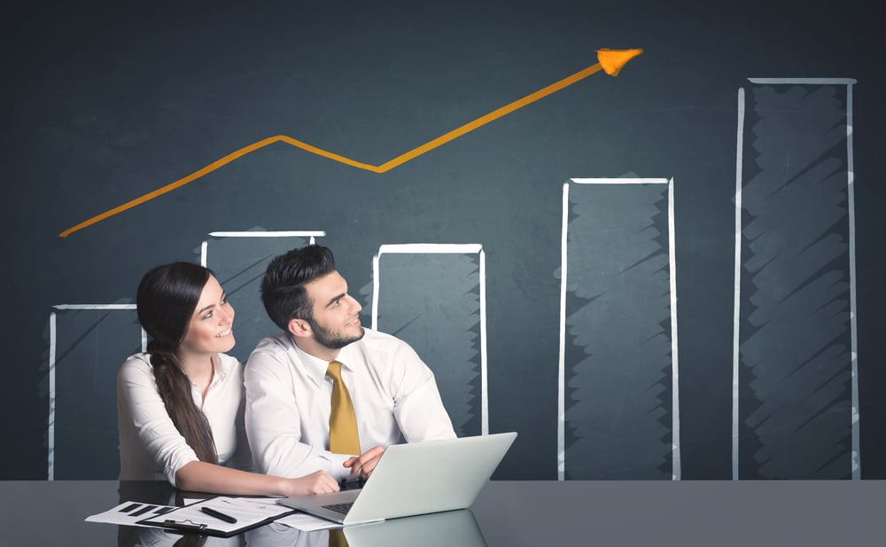 Successful business couple with positive business diagram in background-1